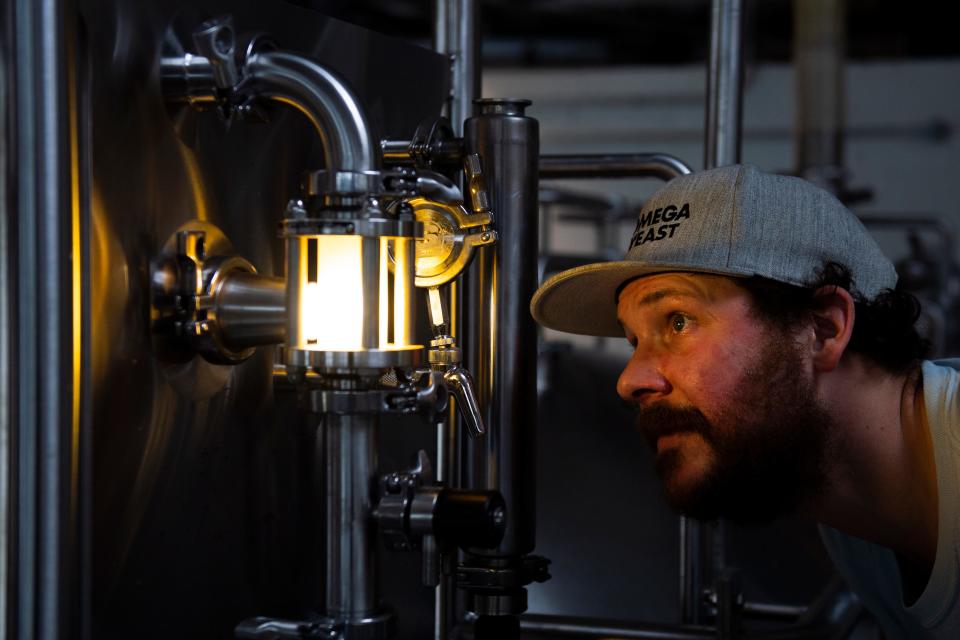 Eli Facchinei works on a batch of Fuego at Tonewood Brewing's new space in Barrington, NJ.