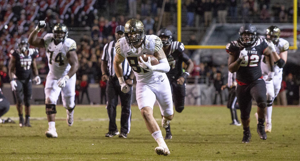 Wake Forest's Jack Freudenthal, middle, breaks free for the game-winning touchdown during the fourth quarter of an NCAA college football game against North Carolina State in Raleigh, N.C., Thursday, Nov. 8, 2018. (AP Photo/Ben McKeown)