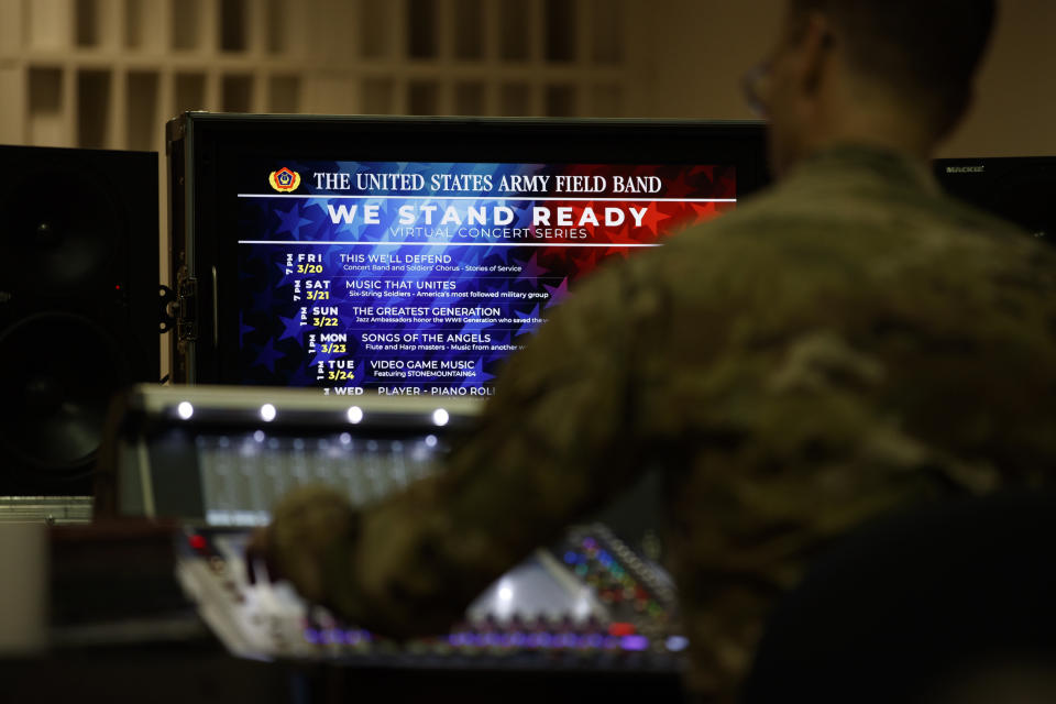 U.S. Army Field Band audio engineer Staff Sgt. Ricky Furr works the sound board during rehearsal of their daily "We Stand Ready" virtual concert series at Fort George G. Meade in Fort Meade, Md., Wednesday, March 25, 2020. The Army Field Band's mission is to bring the military's story to the American people. And they're not letting the coronavirus get in the way. (AP Photo/Carolyn Kaster)