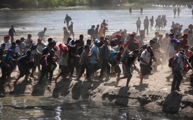 Central American immigrants on the run on Jan. 20, 2020. Poverty and murder in Guatemala linked to government corruption have led thousands to leave their country for the United States.