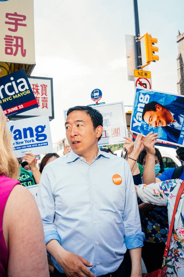 Yang stands amid a crowd of supporters