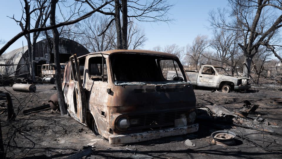 The charred remains of vehicles sit behind a shop that was destroyed by the Smokehouse Creek fire when it burned its way through the Texas Panhandle on March 2, 2024. - Scott Olson/Getty Images
