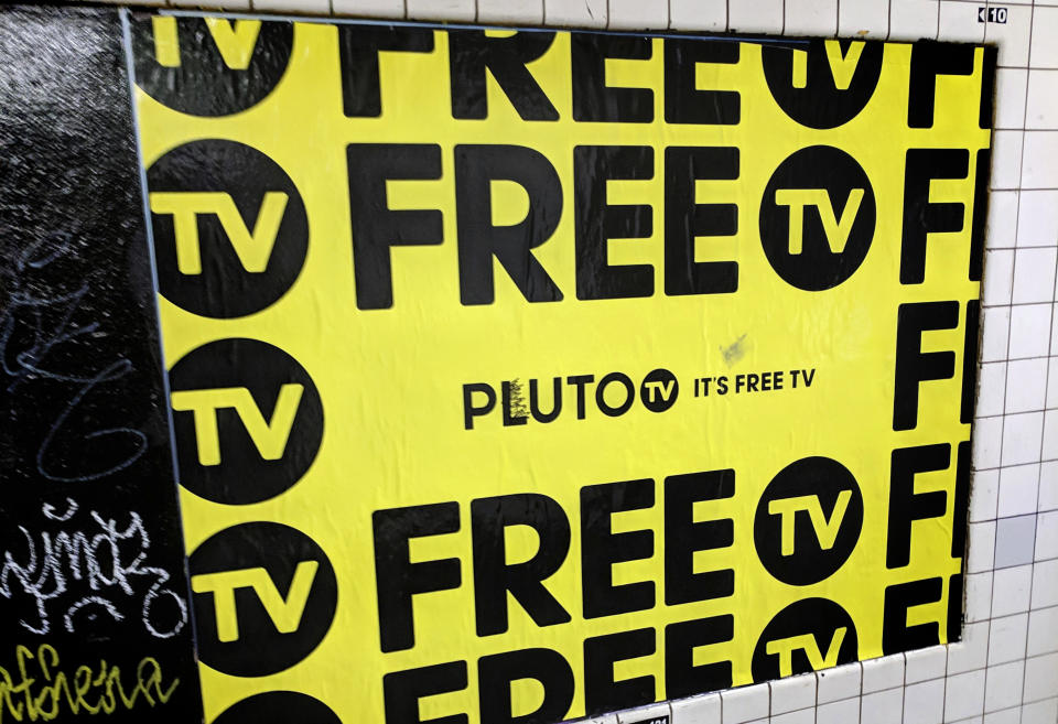 In this March 14, 2019, photo an advertisement for Pluto TV is displayed on the wall of a subway station in New York. Pluto is unusual in that it also offers dozens of channels with “live” video. Though some of these are pretty niche, dedicated to Minecraft or cats, the service is owned by Viacom, so you also get shows from well-known Viacom networks like MTV and Comedy Central. (AP Photo/Tali Arbel)