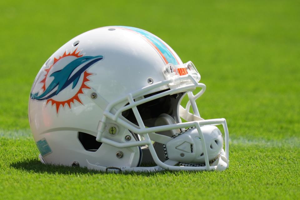 Aug 17, 2022; Miami Gardens, Florida, US; A general view of a Miami Dolphins helmet on the field during practice at Baptist Health Training Complex. Mandatory Credit: Jasen Vinlove-USA TODAY Sports