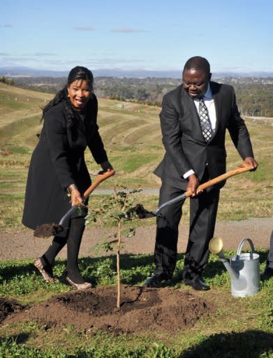 Zimbabwean Prime Minister Morgan Tsvangirai and his wife Elizabeth plant an African walnut tree during a visit to the the National Arboretum in Canberra, on July 23. Zimbabwe is ready to re-engage with the global community, Tsvangirai said during his visit to Australia which said it was open to easing sanctions