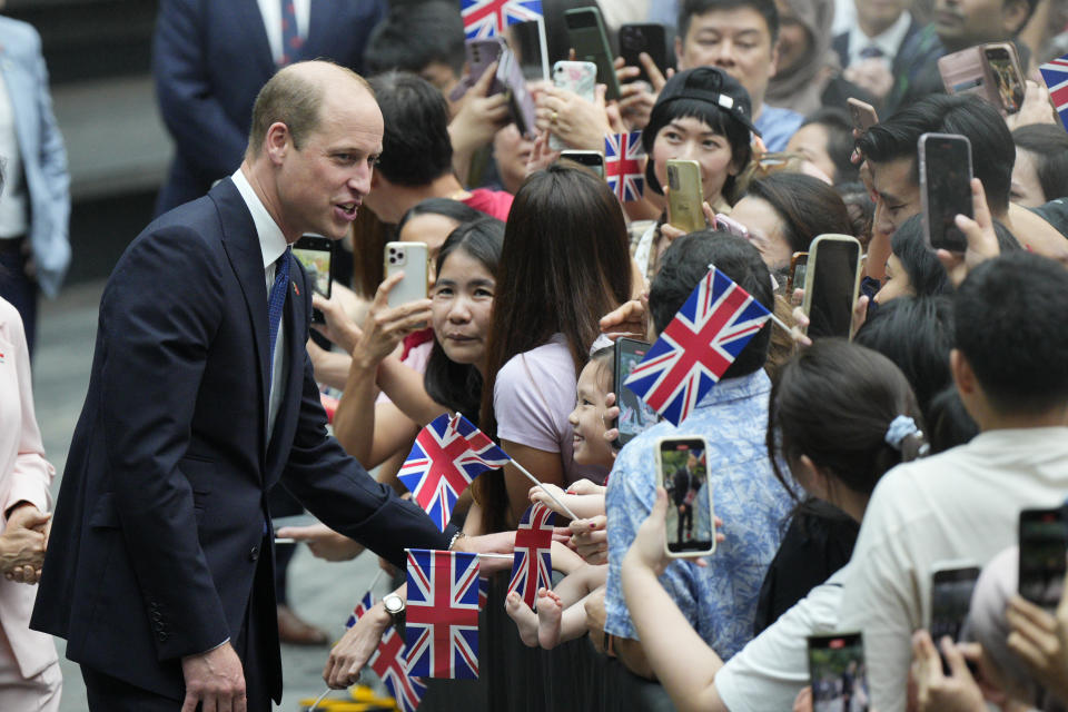 Britain's Prince William, left, greets the public as he arrives at Jewel Changi airport, Singapore, Sunday, Nov. 5, 2023. (AP Photo/Vincent Thian)