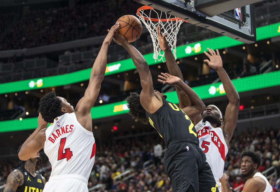 Utah Jazz's Collin Sexton (2) is blocked by Toronto Raptors' Scottie Barnes (4) during first-half preseason NBA basketball game action in Edmonton, Alberta, Sunday, Oct. 2, 2022. (Jason Franson/The Canadian Press via AP)