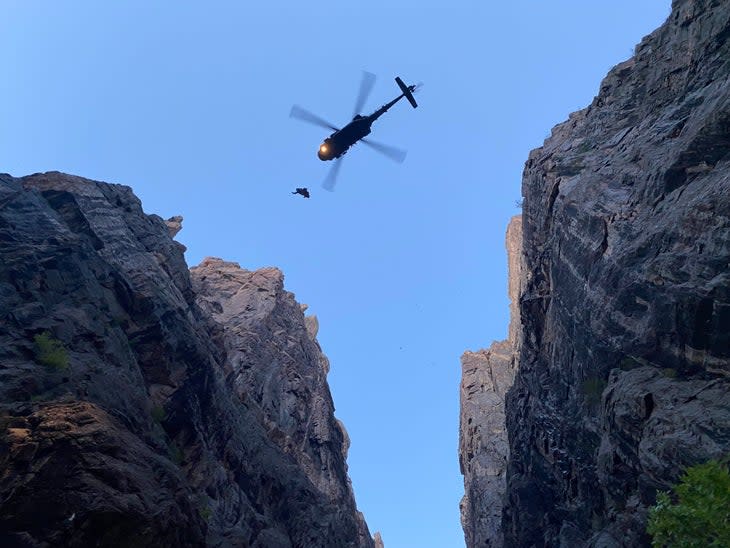 An injured climber and a HAATS flight tech get hauled up into the Black Hawk helicopter at the conclusion of an extremely complex and daring rescue.