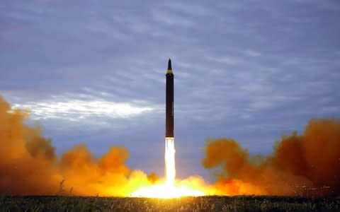 North Korea's intermediate-range strategic ballistic rocket Hwasong-12 lifting off from the launching pad at an undisclosed location near Pyongyang - Credit: AFP