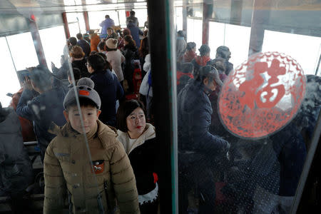 Tourists travel on a boat taking them from the Chinese side of the Yalu River for sightseeing close to the shores of North Korea, near Dandong, Liaoning province, China, November 19, 2017. REUTERS/Damir Sagolj