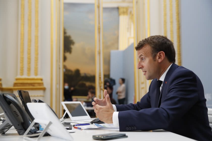 French President Emmanuel Macron speaks with Tedros Adhanom Ghebreyesus, Director General of the World Health Organization and other world leaders about the coronavirus outbreak during a video conference at the Elysee Palace Friday, April 24, 2020 in Paris. Emmanuel Macron urged leaders of the world's biggest economies to "show the world that it's possible to succeed when we are all together and unite our forces." (AP Photo/Christophe Ena, Pool)