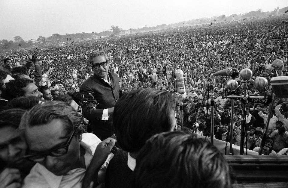 FILE - Bengali nationalist leader Sheikh Mujibur Rahman walks towards a battery of microphones to address an estimated one million people at a rally in Dacca's Race Course Ground in Dacca, Jan. 11, 1972. Bangladesh Prime Minister Sheikh Hasina's political life was shaped by the Aug. 15, 1975 military coup and assassination of her father, Rahman, the first leader of independent Bangladesh. Some say the brutal takeover, which also killed most of her family, pushed her to consolidate unprecedented power. (AP Photo/Michel Laurent, File)