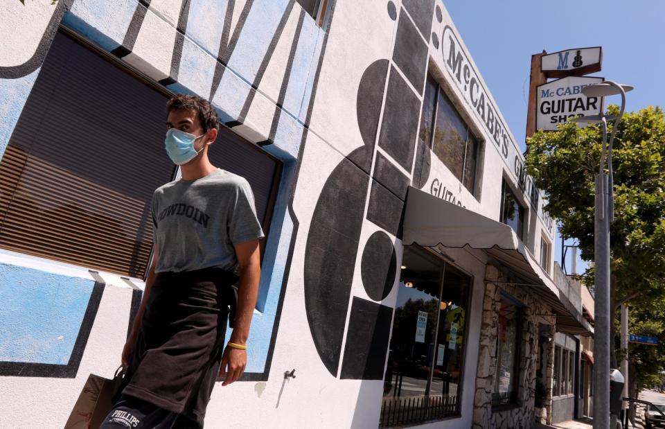 A pedestrian walks past McCabe's Guitar Shop in Santa Monica.