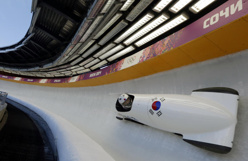 The two-man team from South Korea KOR-2, piloted by Kim Donghyun, speed down the track during the men's two-man bobsled training at the 2014 Winter Olympics, Thursday, Feb. 13, 2014, in Krasnaya Polyana, Russia.