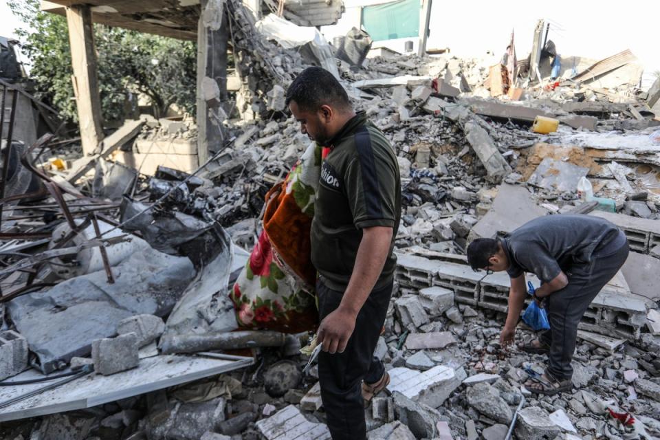 Palestinians inspect demolished buildings after Israeli attacks in Rafah (Anadolu via Getty)