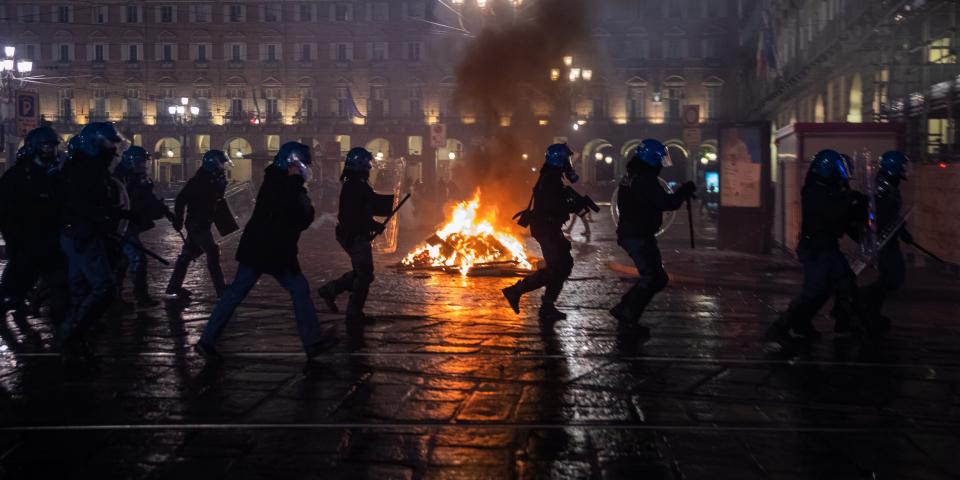 Demonstrators clash with Riot Police during the protest against the lockdown in Piazza Castello on October 26, 2020 in Turin, Italy. The protest is organized to protest against the blockade to restaurant and bars and curfew imposed in the Piedmont Region and by the Italian Government of the evening lockdown which will start from today at 6pm to contain the coronavirus pandemic. (Photo by Mauro Ujetto/NurPhoto via Getty Images)