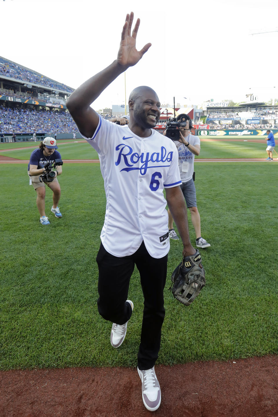 Former Kansas City Royals center fielder Lorenzo Cain waves to fans as he leaves the field after a retirement celebration before a baseball game against the Oakland Athletics in Kansas City, Mo., Saturday, May 6, 2023. Cain signed a one-day contract with the team so he could retire as a Royal. (AP Photo/Colin E. Braley)