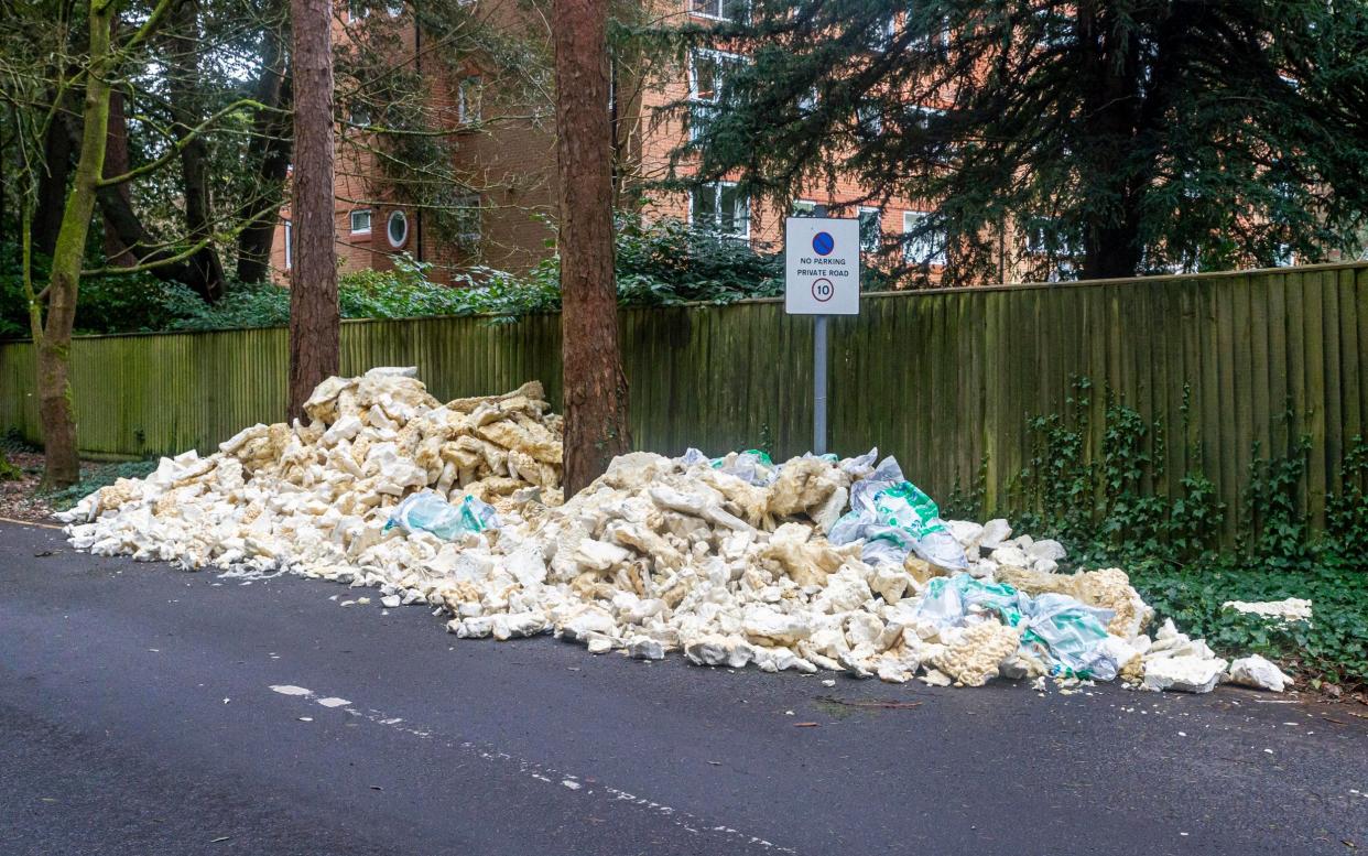 The mountain of roof insulation left at the side of the private road