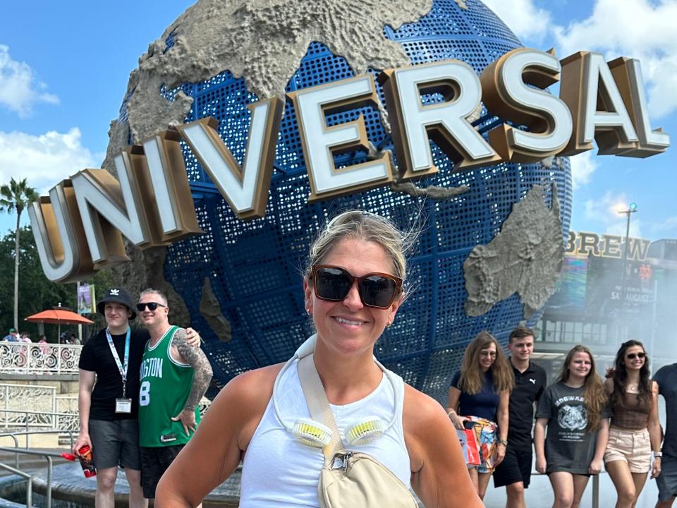 terri posing with universal globe at universal orlando