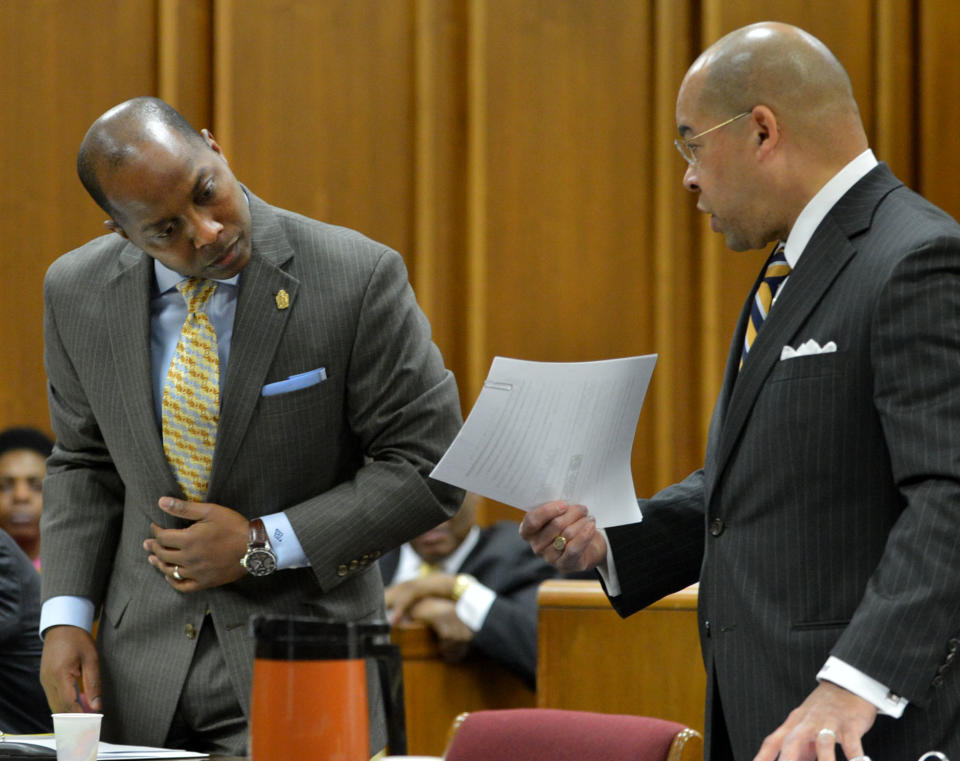 Eric Barnum, left, attorney for Bernice King looks over paperwork held by William Hill, attorney for the Estate of Dr. Martin Luther King Jr. Inc., as they appear in Fulton County Superior Court on Wednesday, Feb. 19, 2014, in the first hearing in the case that has pitted brothers Martin Luther King III and Dexter King against Bernice King over the possession of their father's Nobel Peace Prize and personal Bible. The brothers are seeking a restraining order against their sister, Bernice. (AP Photo/Atlanta Journal-Constitution, Kent D. Johnson) MARIETTA DAILY OUT; GWINNETT DAILY POST OUT; LOCAL TV OUT; WXIA-TV OUT; WGCL-TV OUT.