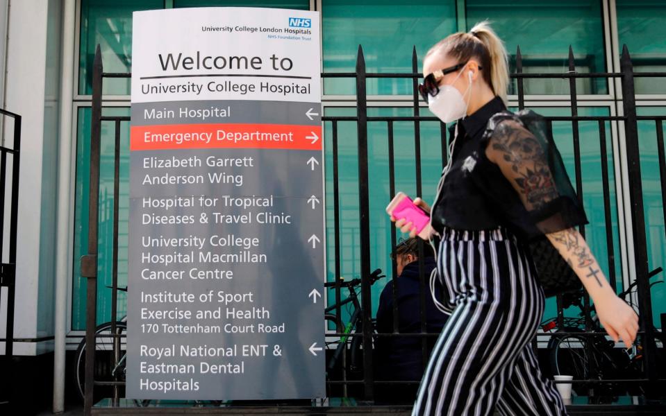 A person wears a face mask outside London's University College Hospital - Tolga Akmen/AFP 