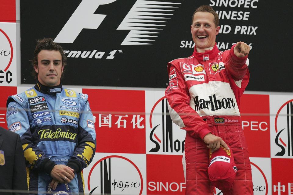 Michael Schumacher of Germany and Ferrari celebrates on the podium as Fernando Alonso looks on after the Formula One Chinese Grand Prix at Shanghai International Circuit on October 1, 2006 in Shanghai, China.  (Photo by Clive Rose/Getty Images)