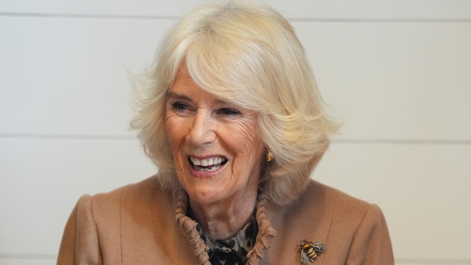 Queen Camilla tries her hand at crafting a spring wreath during a visit to the recently restored Shrewsbury Flaxmill Maltings