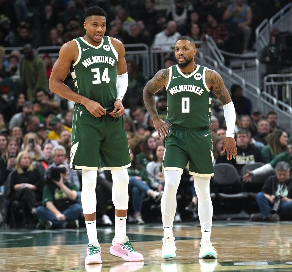 Milwaukee Bucks forward Giannis Antetokounmpo (34) and guard Damian Lillard (0) talk during the first half of their game against the Detroit Pistons on Dec. 16, 2023, at Fiserv Forum in Milwaukee.