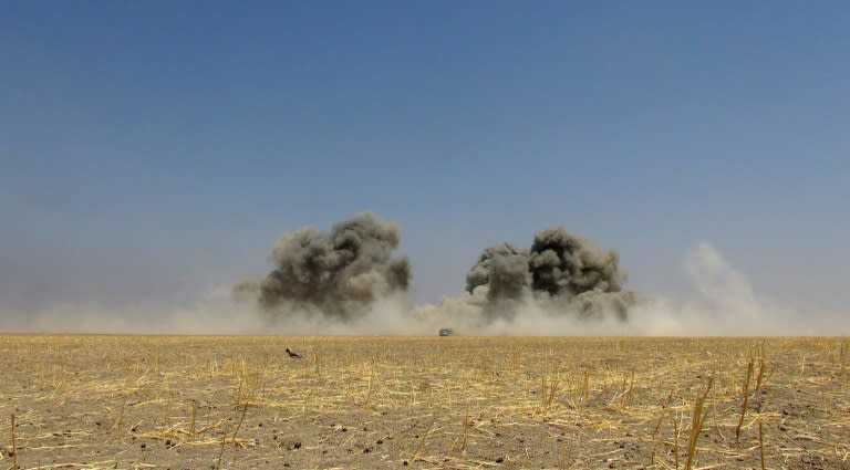 Smoke billowing above the wreckage of a Russian Mi-8 military transport helicopter after it was shot down along the administrative border between Idlib province and neighbouring Aleppo