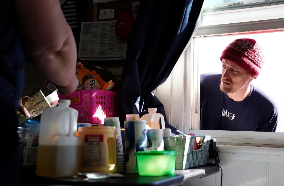 Jacob Melanson, rights, waits for his hot coffee that Teresa Routte will make at the HOPE Resource Center on Sullivant Ave. in Columbus, Ohio on February 21, 2022. The mission of the HOPE Resource Center is to provide compassionate care to those in active addiction and to provide them with the resources they need to enrich and transform their lives.