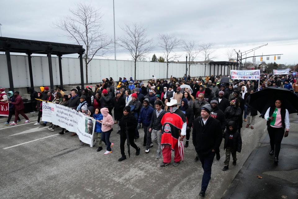 Jan 16, 2023; Columbus, Ohio, USA;  Hundreds walk together down East Spring Street during the The City of Columbus’ 2023 Martin Luther King Jr. march on Monday evening. Mandatory Credit: Joseph Scheller-The Columbus Dispatch