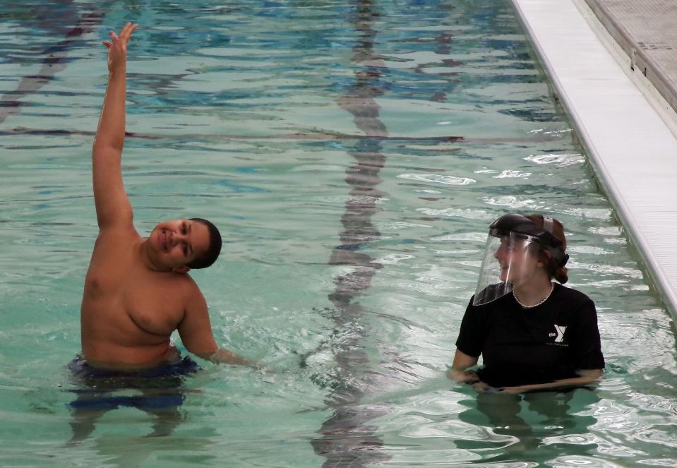 Isaiah Pina of Middleboro, left, who is 10 years old and has autism, brings a lot of energy and enthusiasm to his swimming and water safety class at the Middleboro YMCA on Sunday, Jan. 20, 2022. That makes for a fun lesson for instructor Meghan Tatarczuk.