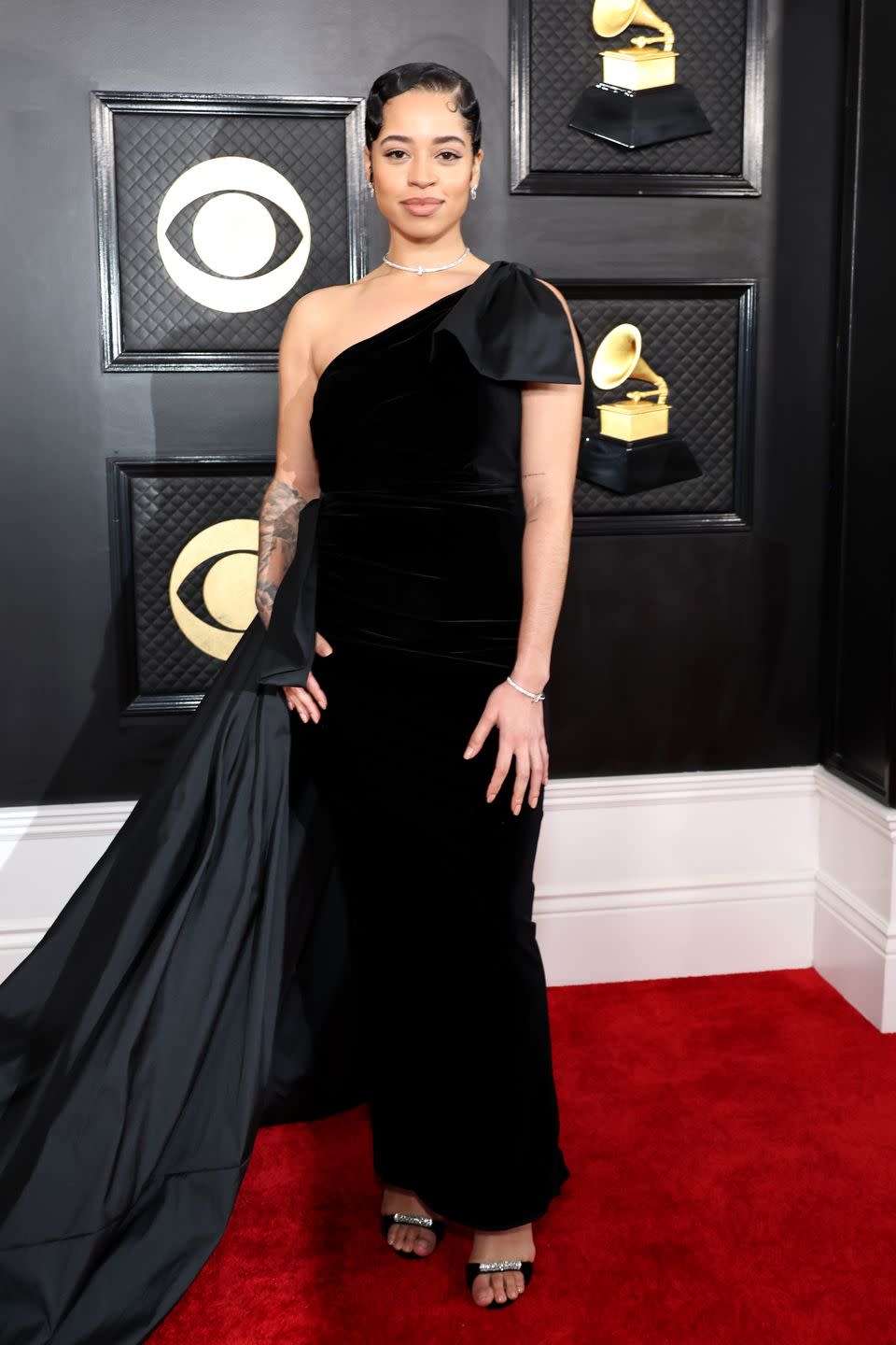 <p>While black was a common theme on the <a href="https://www.harpersbazaar.com/celebrity/red-carpet-dresses/g42398612/best-dressed-red-carpet-fashion-golden-globes-2023/" rel="nofollow noopener" target="_blank" data-ylk="slk:Golden Globes red carpet;elm:context_link;itc:0;sec:content-canvas" class="link ">Golden Globes red carpet</a>, the Grammys are known for being a bit more extreme (and often sequined, and neon). Ella Mai brought an Old Hollywood look to the evening, with an off-the shoulder gown tied with an oversized bow.</p>