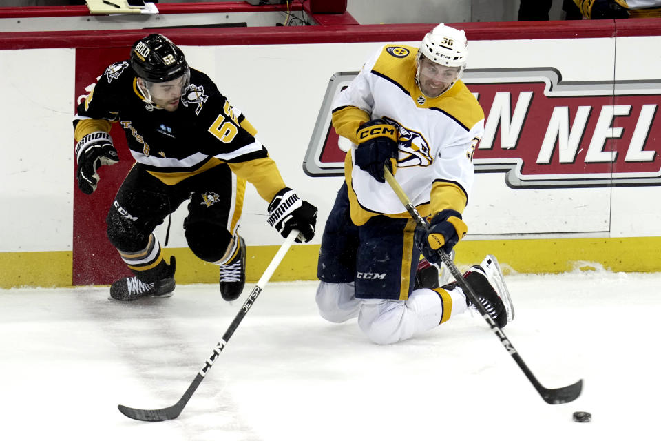Nashville Predators' Cole Smith (36) gets off a pass after colliding with Pittsburgh Penguins' Mark Friedman during the first period of an NHL hockey game in Pittsburgh, Thursday, March 30, 2023. (AP Photo/Gene J. Puskar)