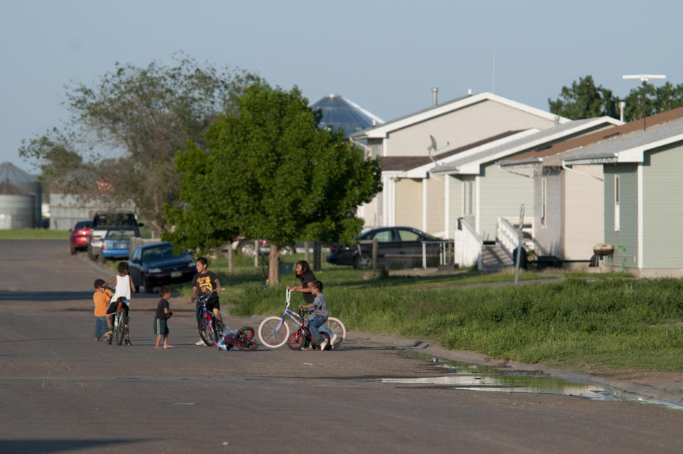 Children playing on a street in a housing development in Poplar, Montana on the Ft. Peck Indian Reservation. The tribes on the reservation are Assiniboine and Sioux. (Photo by William Campbell/Corbis via Getty Images)