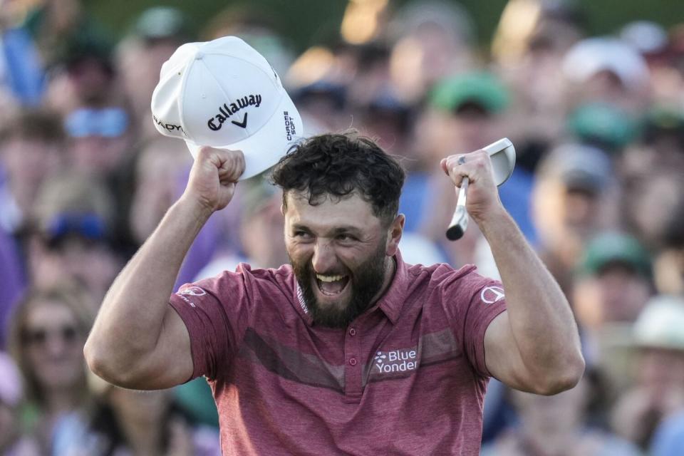 Jon Rahm celebrates on the 18th green after winning the Masters on Sunday.