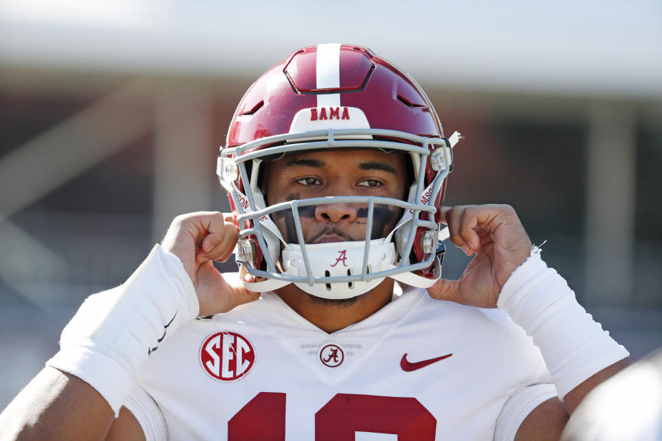 FILE - In this Nov. 16, 2019, file photo, Alabama quarterback Tua Tagovailoa (13) adjusts his helmet before an NCAA college football game against Mississippi State in Starkville, Miss. Miami Dolphins newcomer Tua Tagovailoa is starting to connect with his receivers. And for now, veteran receiver Albert Wilson said Wednesday, May 13, 2020 long-distance hookups with the rookie quarterback will have to do. (AP Photo/Rogelio V. Solis, Fle)