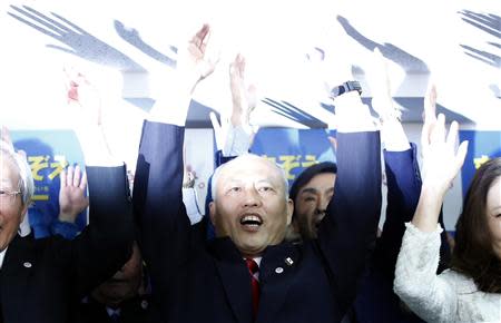 Japan's former Health Minister Yoichi Masuzoe (C) shouts "banzai" (cheers) with his supporters at his office in Tokyo February 9, 2014. REUTERS/Yuya Shino