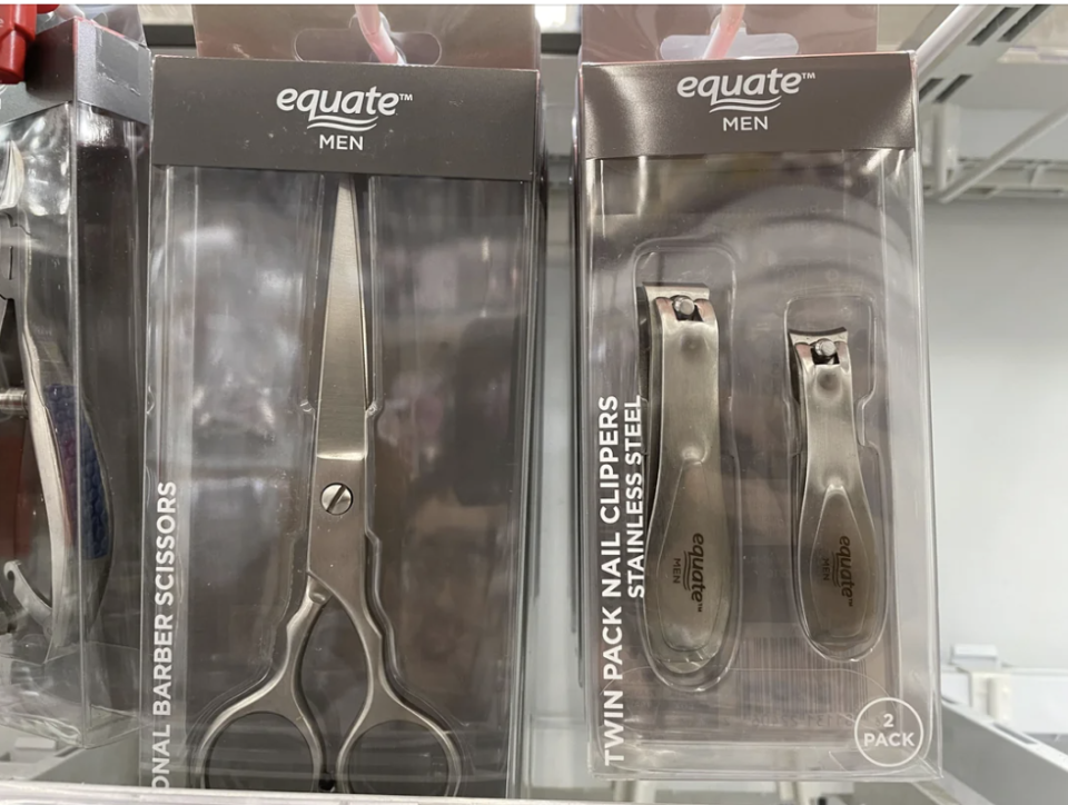 Two Equate Men's grooming products on a shelf: barber scissors and nail clippers set