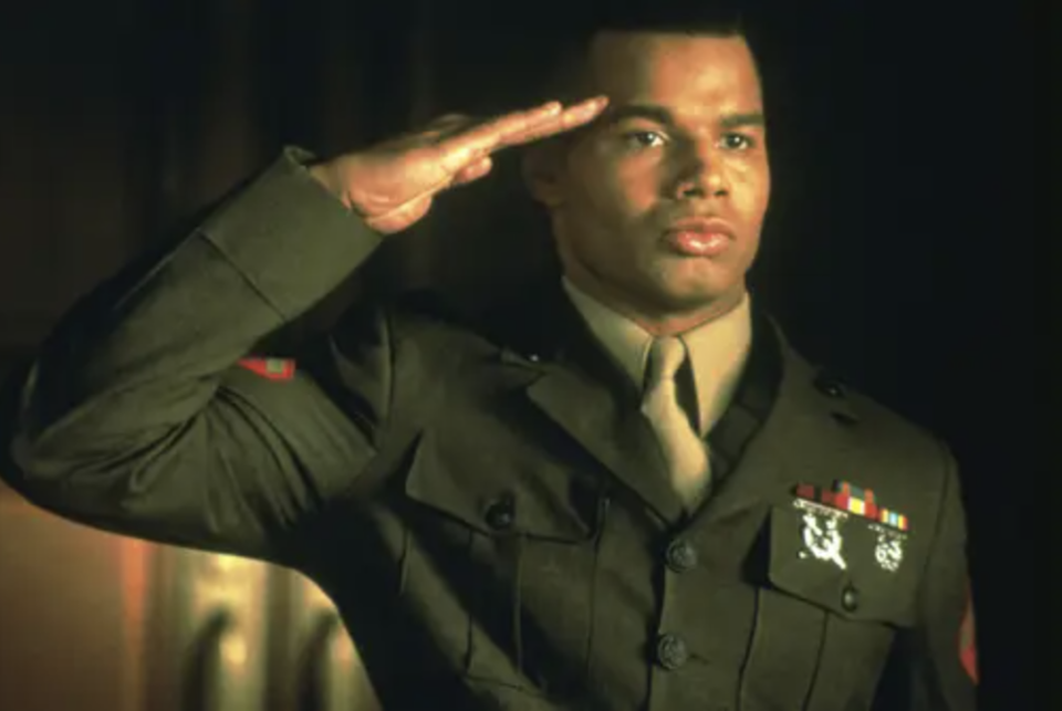 Bodison salutes in a military uniform