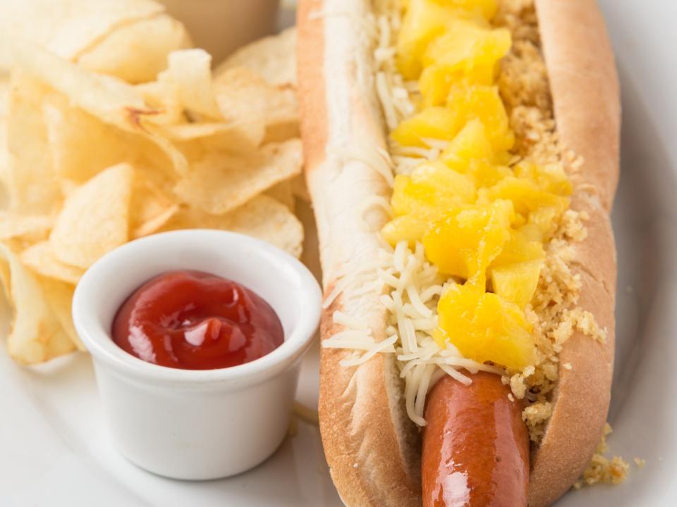 pineapple hot dog with chips and ketchup