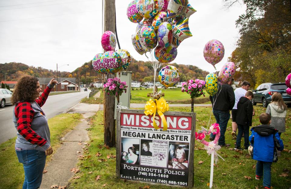 Kadie Lancaster and her family decorate Megan Lancaster's missing sign on what would be her 33rd birthday, Saturday, Oct. 24, 2020. Kadie is the sister-in-law of Megan, who went missing in 2013. She's been fighting for justice for her friend ever since. The timing of Megan's birthday came just one day after Michael Mearan, prominent Portsmouth, Ohio attorney and former council members was indicted on 18-counts of sex trafficking. Kadie has long alleged Mearan was somehow involved with Megan's disappearance.