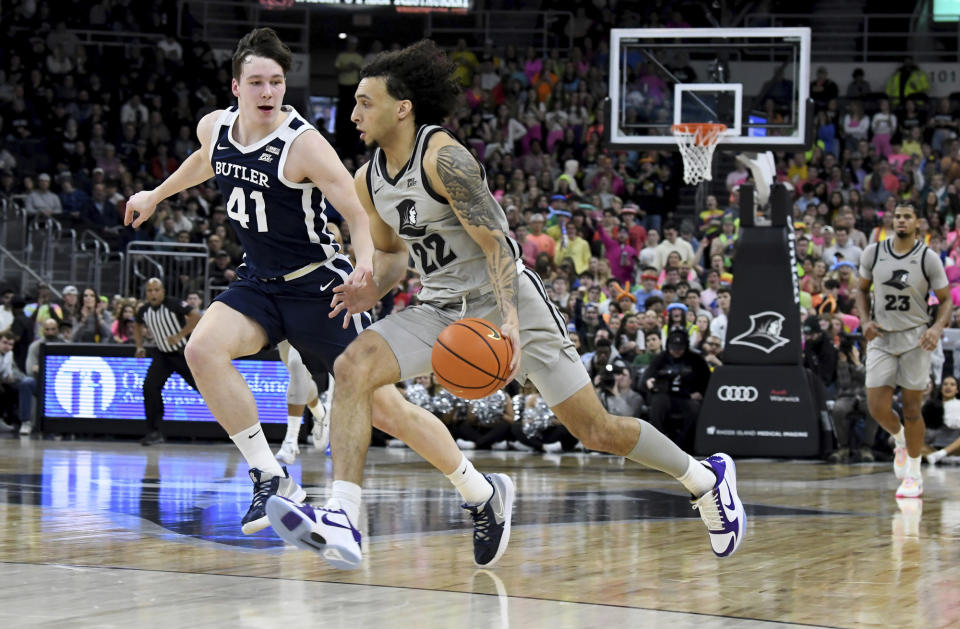 Providence's Devin Carter (22) dribbles around Butler's Simas Lukosius (41) during the first half of an NCAA college basketball game, Wednesday, Jan. 25, 2023, in Providence, R.I. (AP Photo/Mark Stockwell)