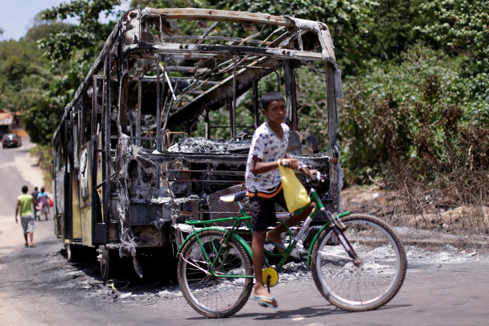 A bus is pictured after it was set on fire during violent disturbances