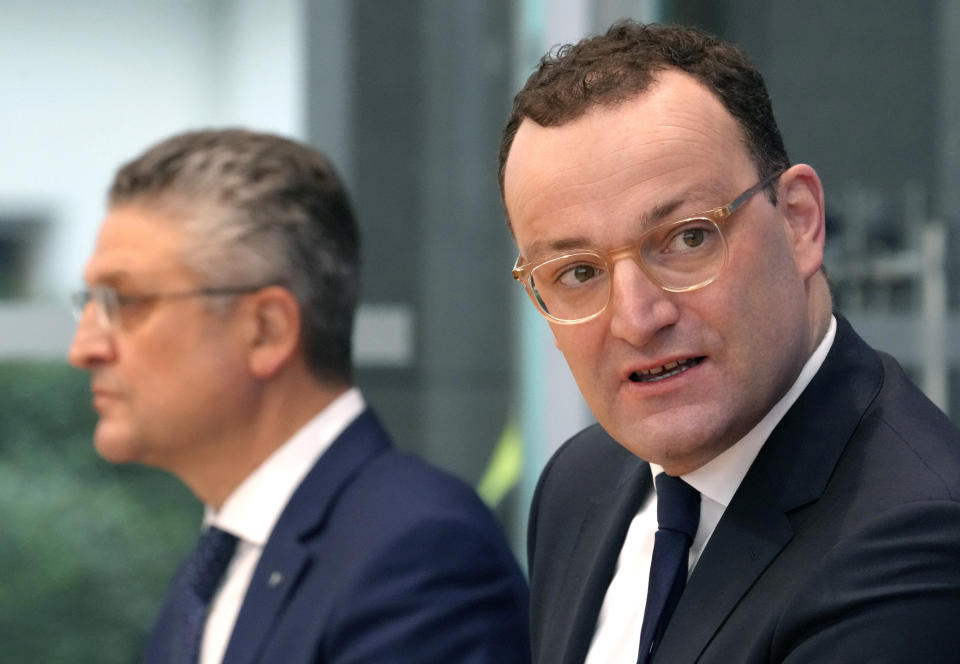 German Health Minister Jens Spahn, right, and Lothar H. Wieler, left, president of the Robert-Koch-Institute German national agency and research institute, responsible for disease control and prevention, attend a press conference on the current coronavirus pandemic in Berlin, Germany, Friday, Nov. 12, 2021. (AP Photo/Michael Sohn)