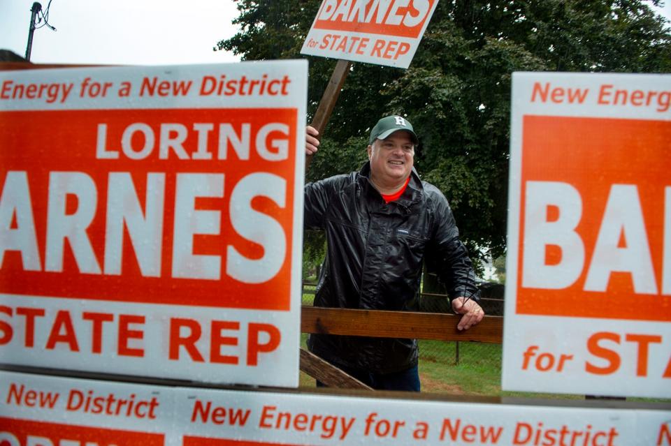 Jim Mirabile, chairman of the Hopkinton Republican Town Comittee, with signs for Loring Barnes, candidate for the Middlesex 8th District seat, at the entrance to the Hopkinton Middle School gymnasium voting place, Sept. 6, 2022.