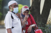 Relatives of Panca Widia Nursanti, a victim in the Sriwijaya Air passenger jet crash, cry at a hospital in Jakarta, Indonesia, Tuesday, Jan. 12, 2021. Indonesian navy divers were searching through plane debris and seabed mud Tuesday looking for the black boxes of the Sriwijaya Air jet that nosedived into the Java Sea over the weekend with 62 people aboard. (AP Photo/Achmad Ibrahim)