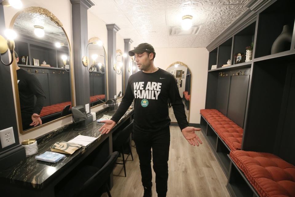 Nicholas Lopez, creative director for the LeBron James Family Foundation, show a dressing room during a tour of House Three Thirty in Akron.