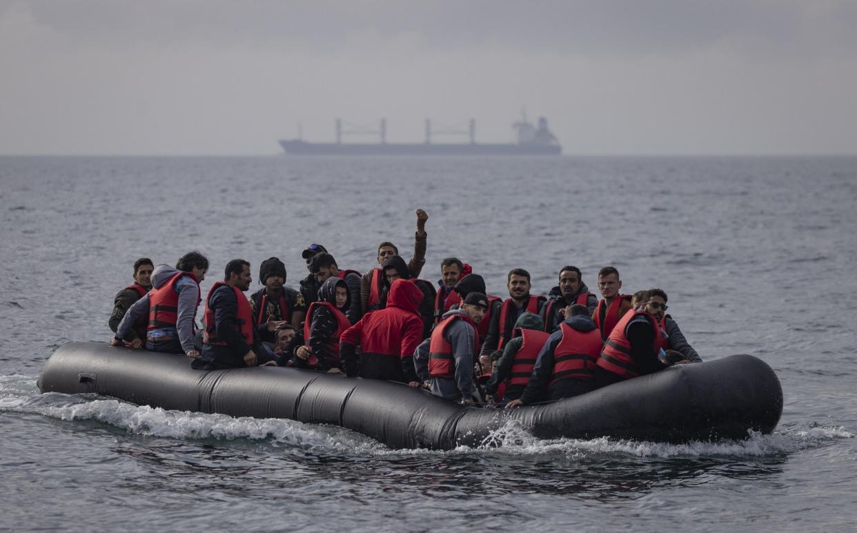 An inflatable craft carrying migrants crosses the shipping lane in the English Channel