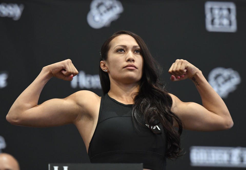 Seniesa Estrada flexes during a weigh-in.